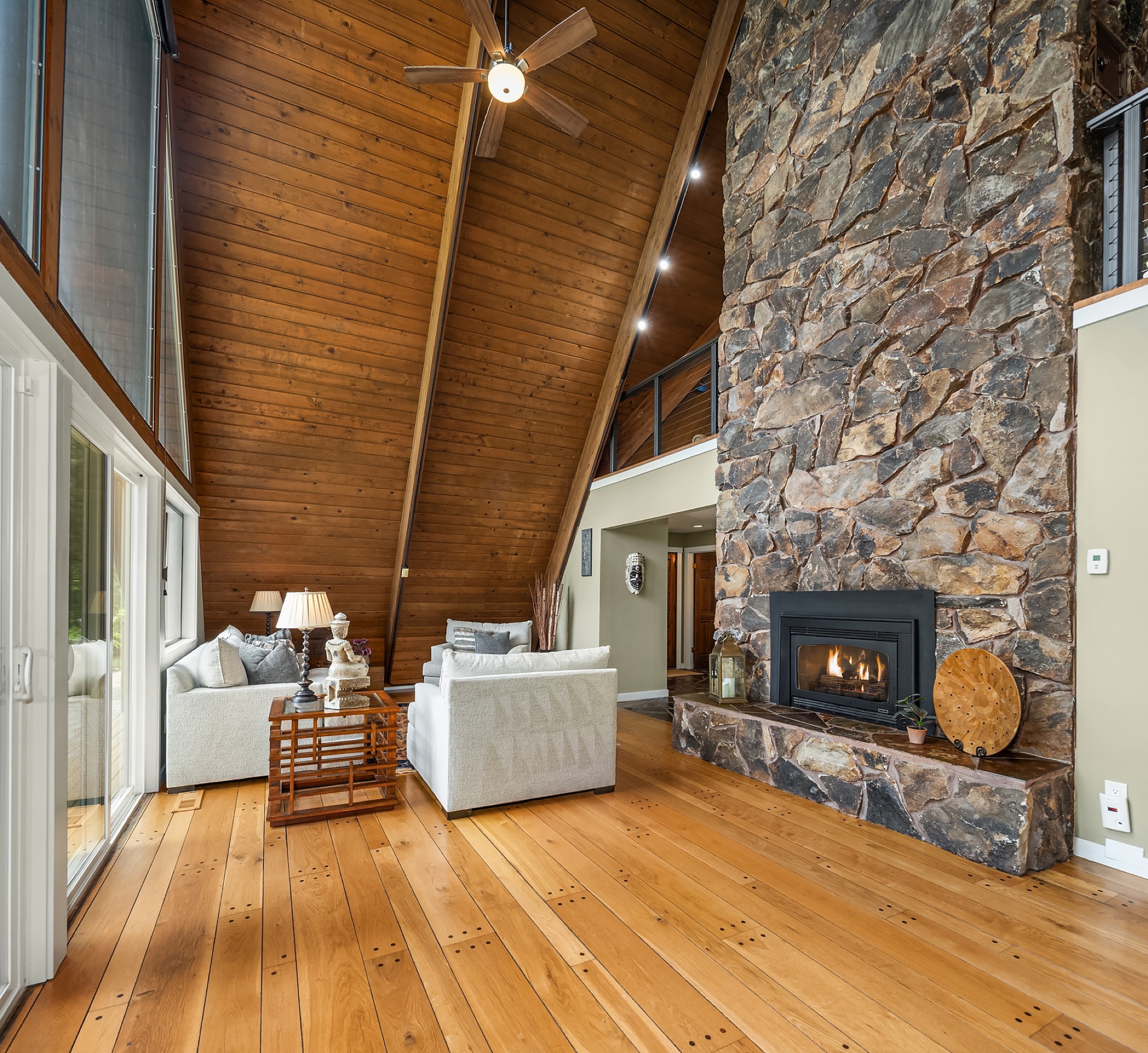 Floor-to-peak stone fireplace
